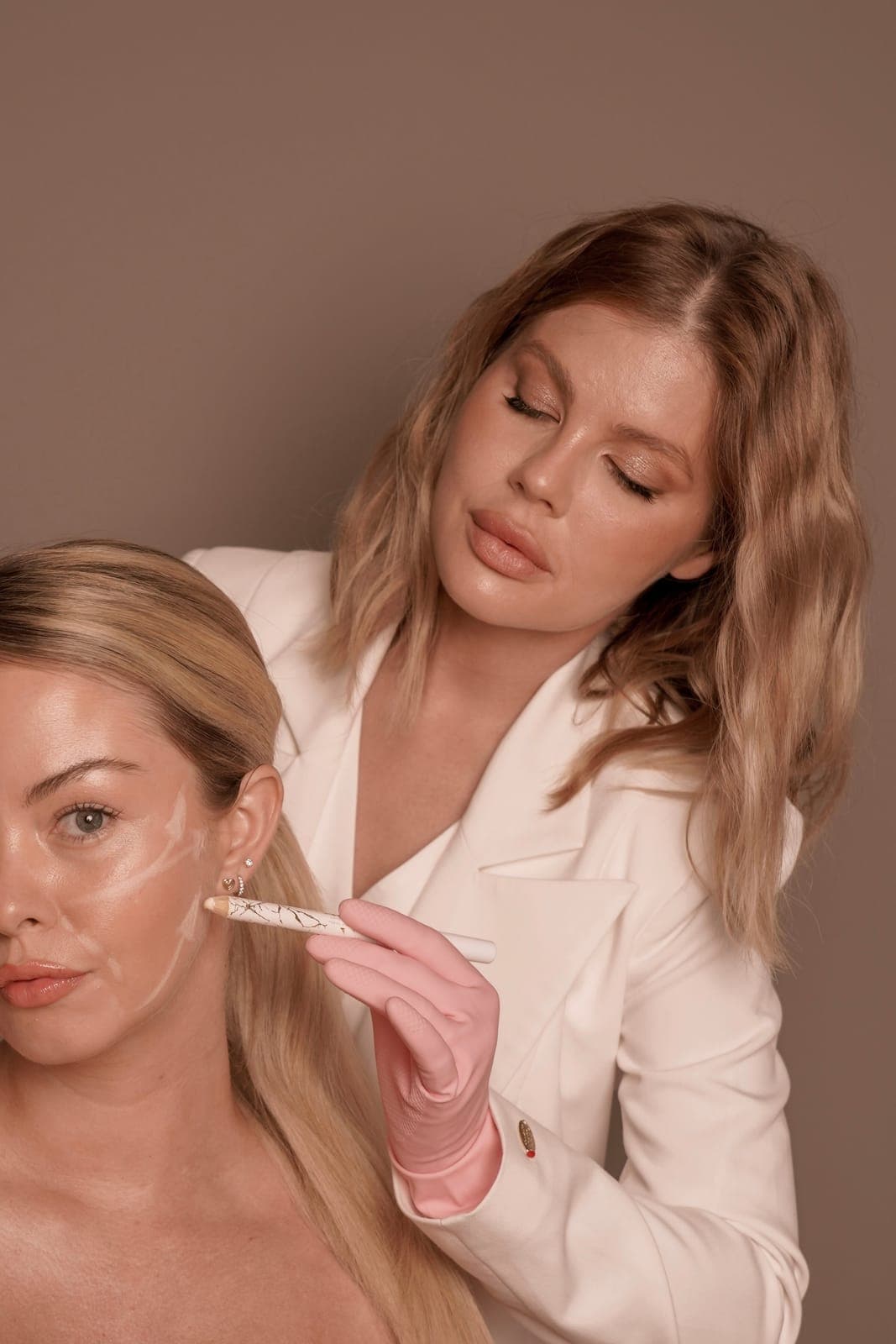 Dr Kate marking a patient's face before treatment